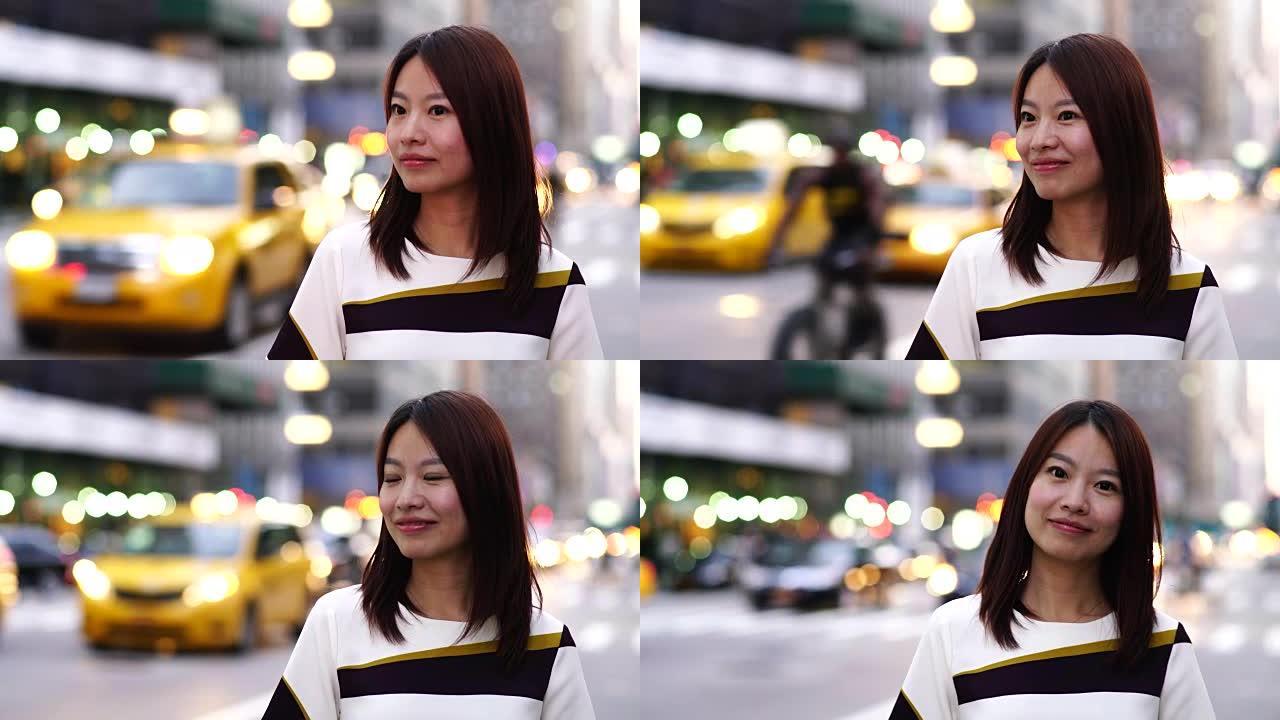 美丽的亚洲女性穿着漂亮的衣服站在城市环境中。城市生活背景。