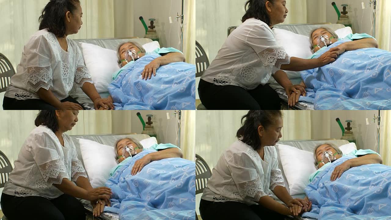 一位妇女在医院的病床上看着她的妈妈