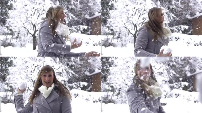 慢动作: 年轻女子将雪球扔进相机