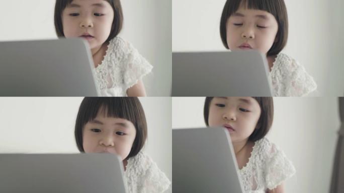 女儿在笔记本电脑上观看Youtube