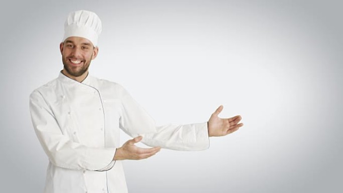 微笑的厨师在胸前摆出手势，双手交叉。以白色背景拍摄。