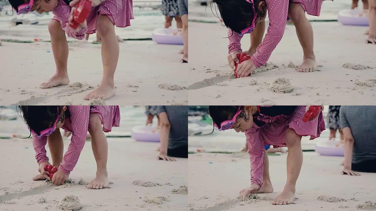 小女孩在沙滩上玩沙子