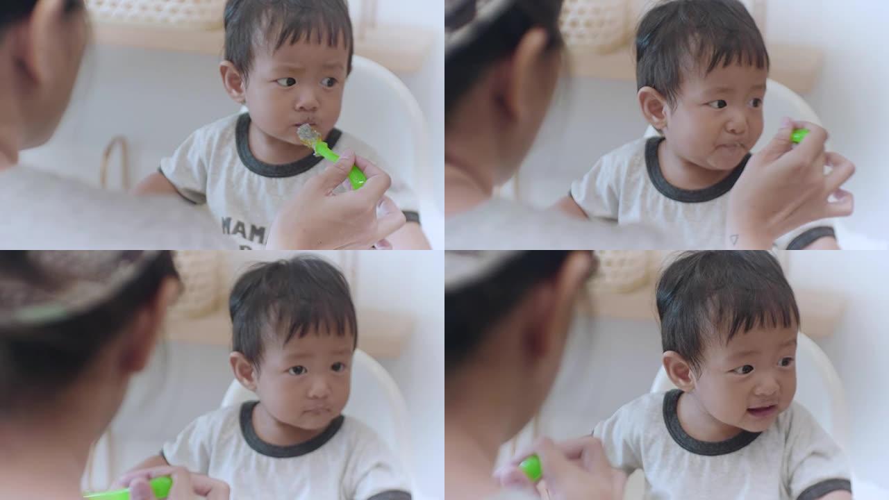 亚洲男婴 (6-11个月) 在家吃婴儿食品