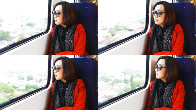 美丽的亚洲女人在火车上旅行。