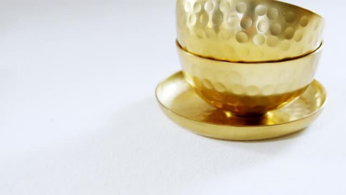白色背景上的金色钢碗和盘子4k