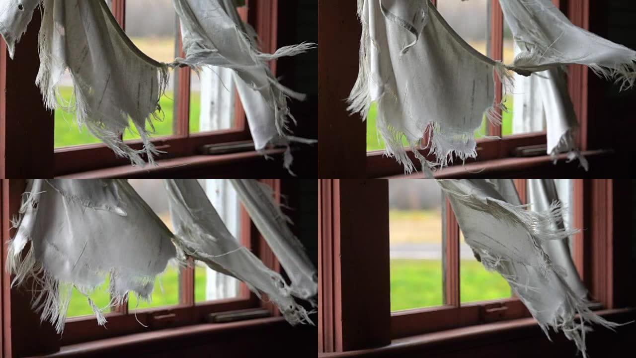 慢动作: 旧房子窗户上的破烂窗帘在风中拍打