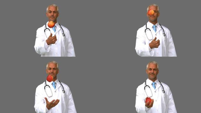医生在灰色屏幕上扔苹果