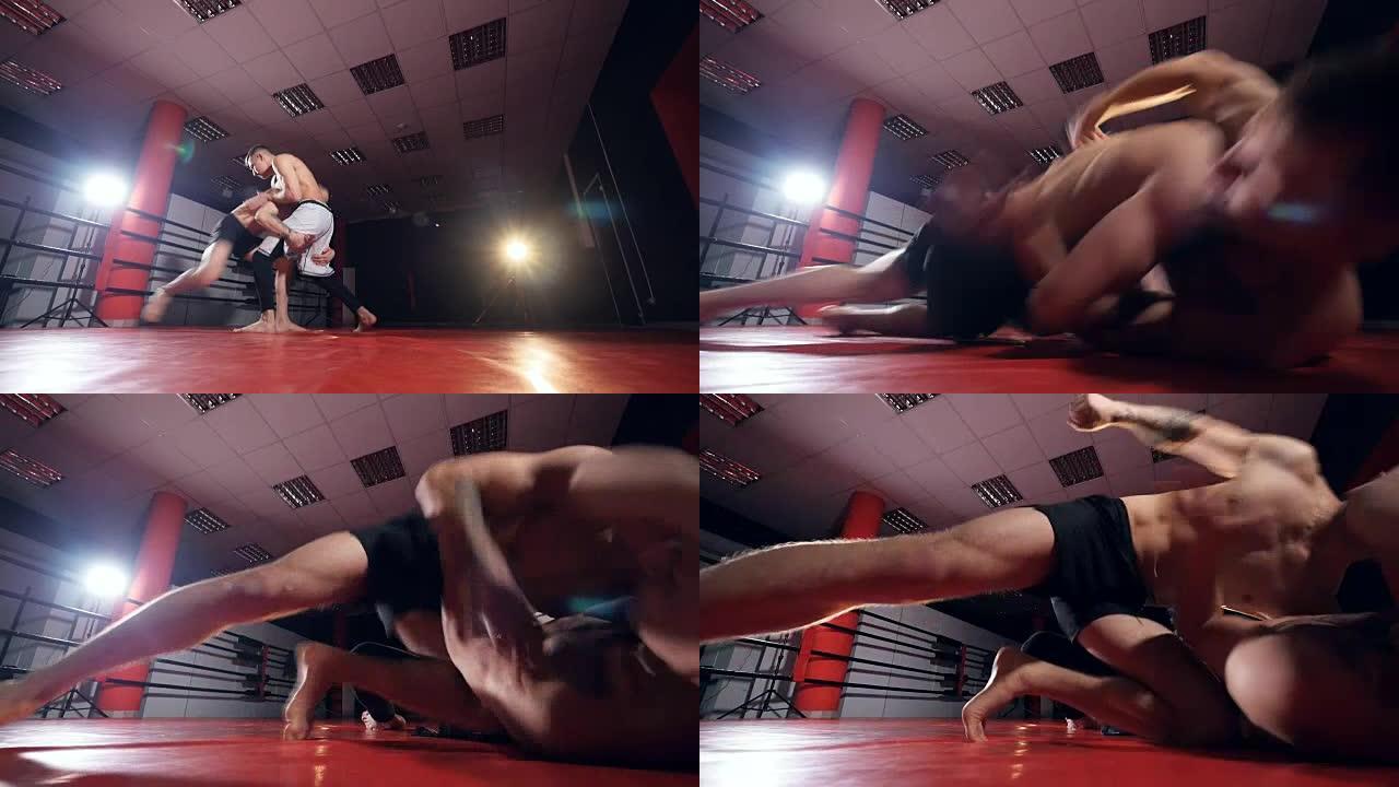 MMA战士在黑暗中争吵。慢动作，稳定镜头