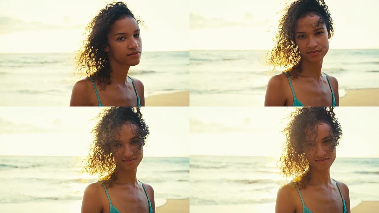 日落时海滩上美丽年轻女子的肖像，柔和温暖的复古色调