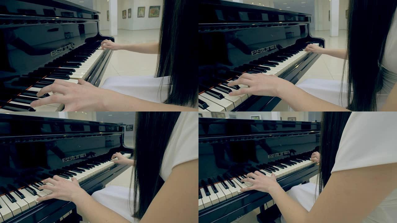 不知名的女孩在弹钢琴。稳定。特写。4K。