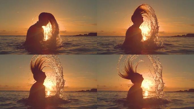 剪影: 年轻女子将头发向后鞭打，并在日落时泼水。