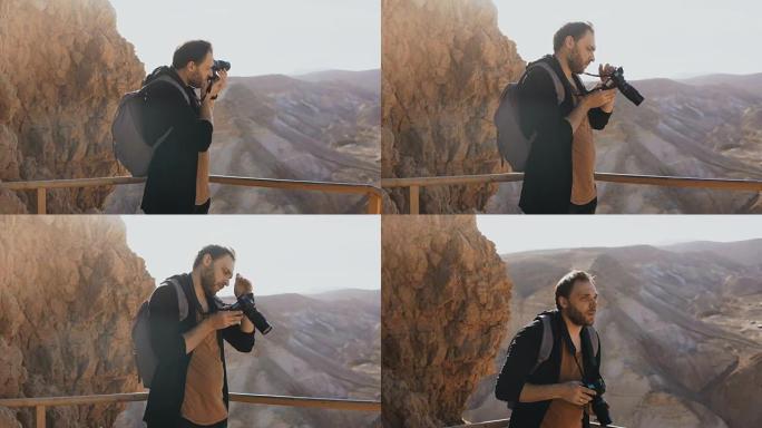 男人拍了大片山景的照片。白人男性拿着相机照片，看着他的相机。以色列4K