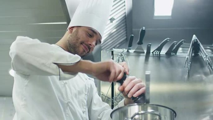 快乐的专业厨师在餐厅或酒店的商业厨房里准备汤。