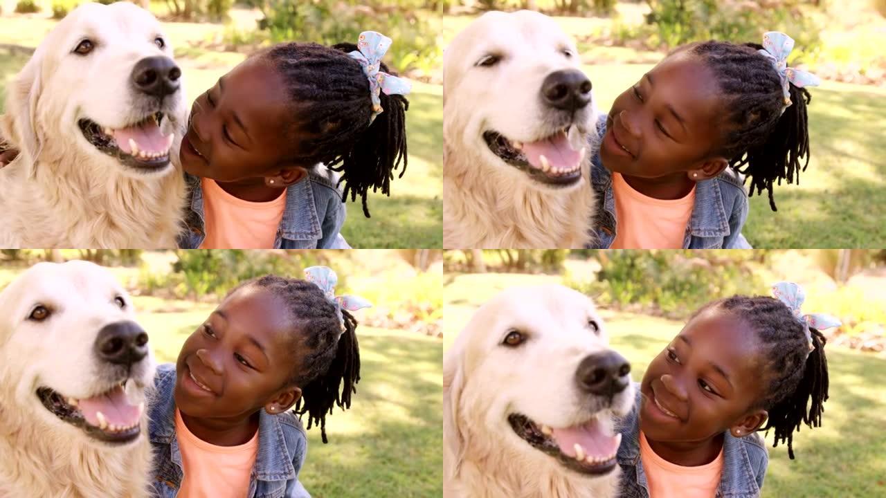 可爱的女孩的肖像正在抚摸一只狗