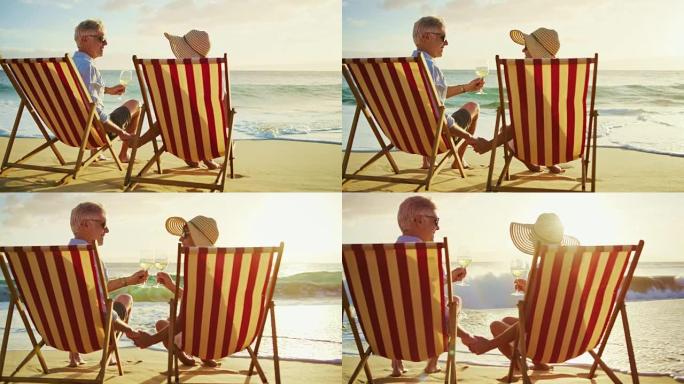 夫妇在海滩上放松享受日落