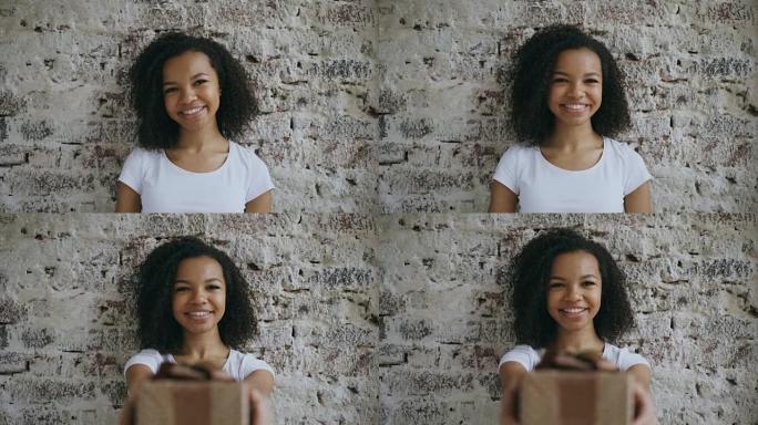 卷曲的非洲裔美国女孩的肖像赠送礼品盒，微笑着走进相机