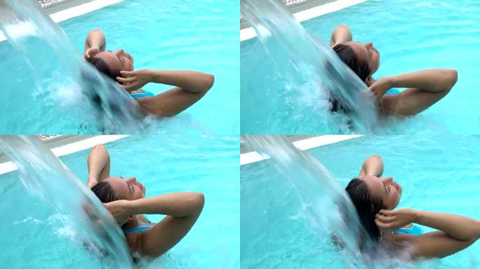 美丽的拉丁美洲女人在游泳池边弄湿头发