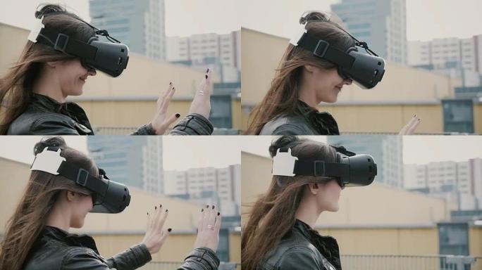 挥舞着头发的黑发女孩在屋顶上使用3D虚拟现实耳机。全高清