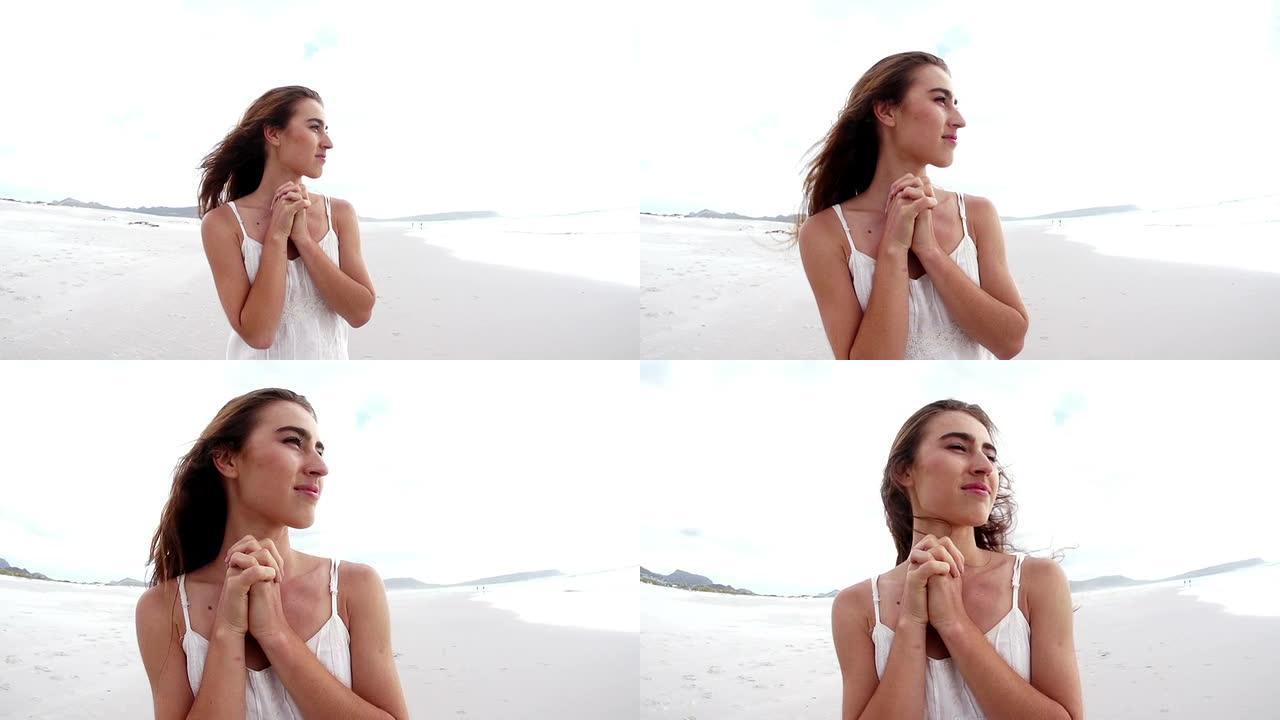 女孩在海滩祈祷