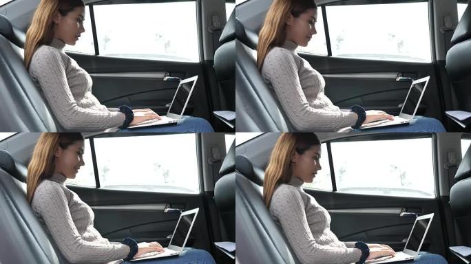 在汽车上使用笔记本电脑的女人
