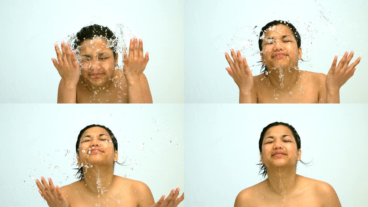 幸福的女人在脸上泼水