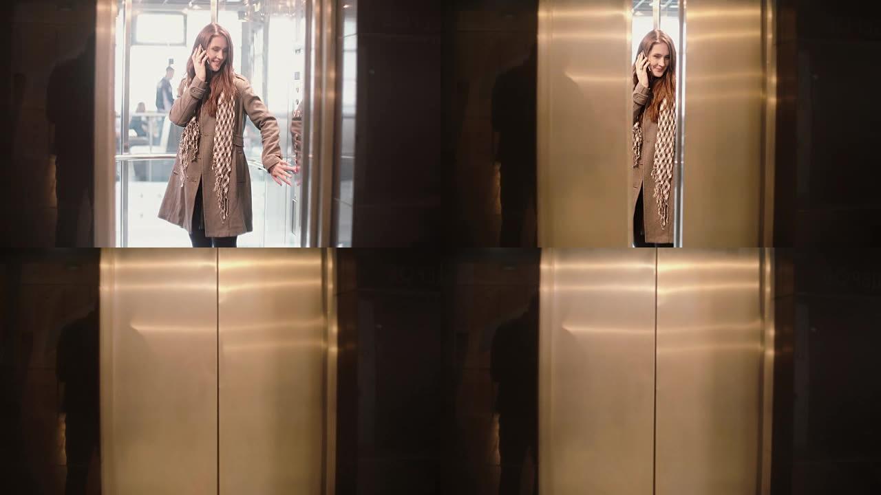 女人站在电梯里，用智能手机聊天。女性按下按钮，门关闭