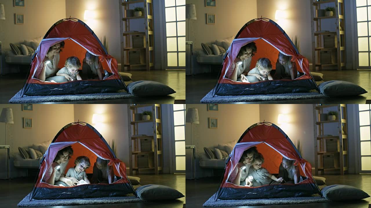 帐篷里的家庭阅读故事书