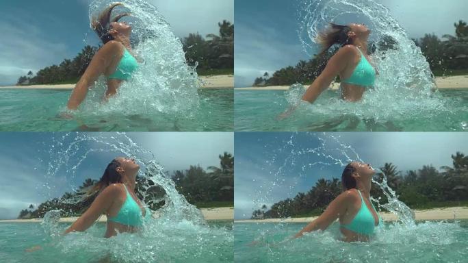 慢动作: 年轻女子将头从海洋中拉出并喷水