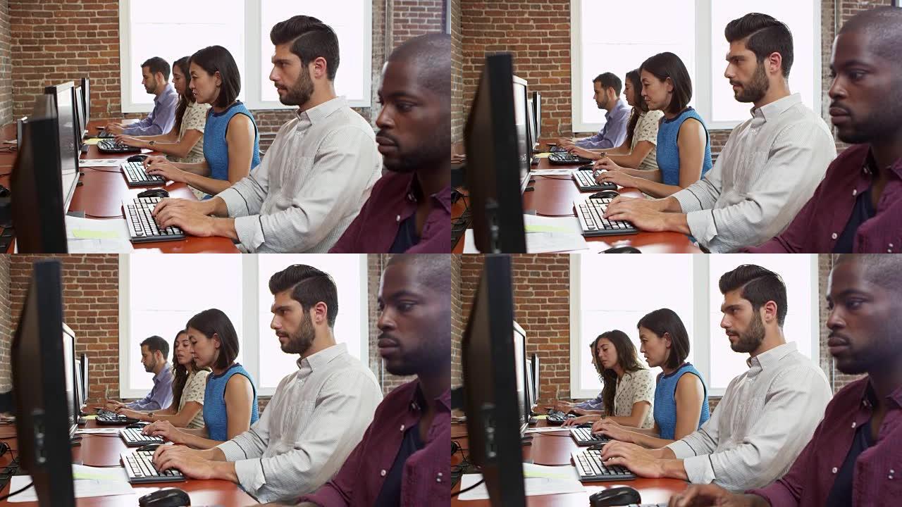 员工在R3D上使用坐在办公室办公桌上的计算机