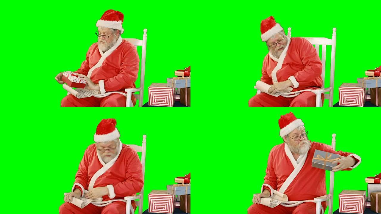 圣诞老人拿着卷轴和礼品盒