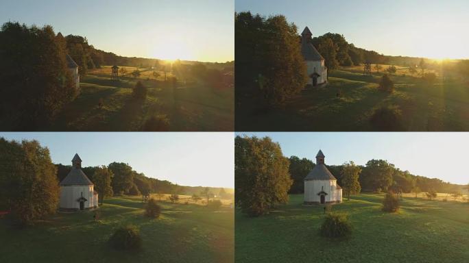 太阳女士照耀着斯洛文尼亚Prekmurje宁静，田园诗般的乡村景观和圆形教堂