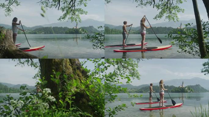 慢动作: 年轻夫妇在约会时站在SUP板上划桨