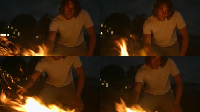 男子在晚上照看篝火