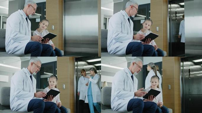 在医院的大厅里，男医生坐在沙发上与一个可爱的小女孩交谈，他正在向她展示平板电脑上的信息。繁忙的现代医