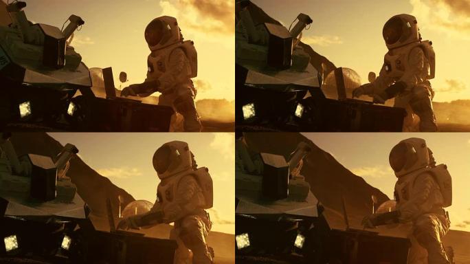 宇航员穿着宇航服在一台笔记本电脑上工作，在一个新的外星红色星球/火星上调整火星车。日光高科技太空探索