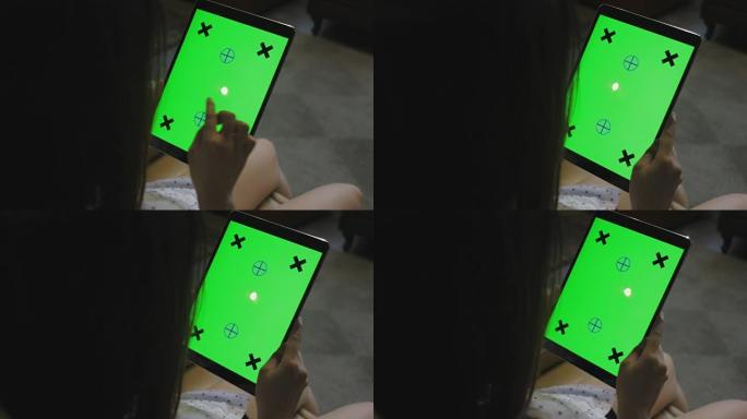 东南亚女人看着平板电脑绿屏