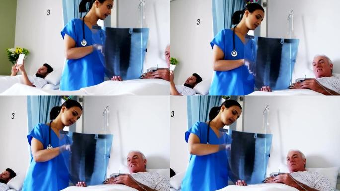女医生在病房与男性老年患者讨论x射线报告