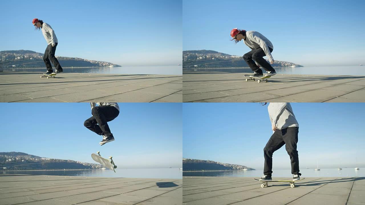 慢动作dop: 滑板手在混凝土海岸跳跃并进行翻转技巧