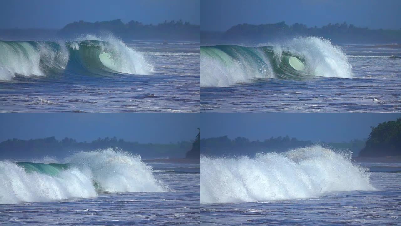 慢动作: 大的shorebreak波撞击沙洲，飞溅着闪闪发光的水滴