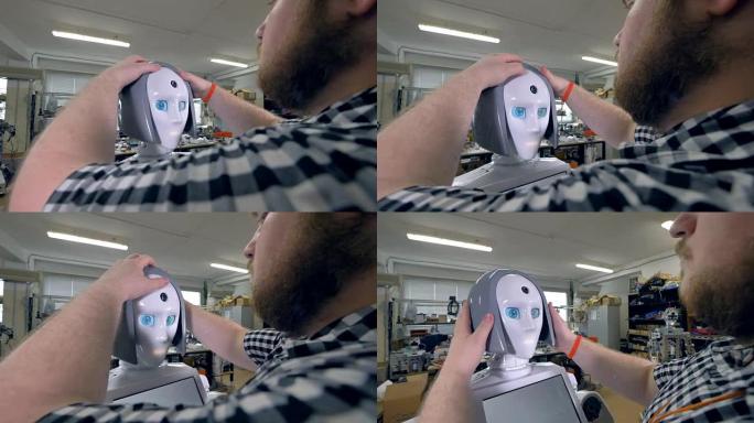 工程师将灰色塑料假发戴在机器人头上。