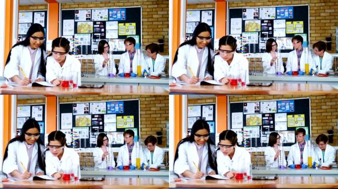 女学生在学校实验室进行实验时在日记中写作
