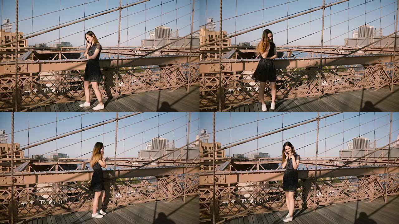 漂亮微笑的高加索轻浮女孩在布鲁克林大桥与朋友通电话，慢慢地来回走动4K