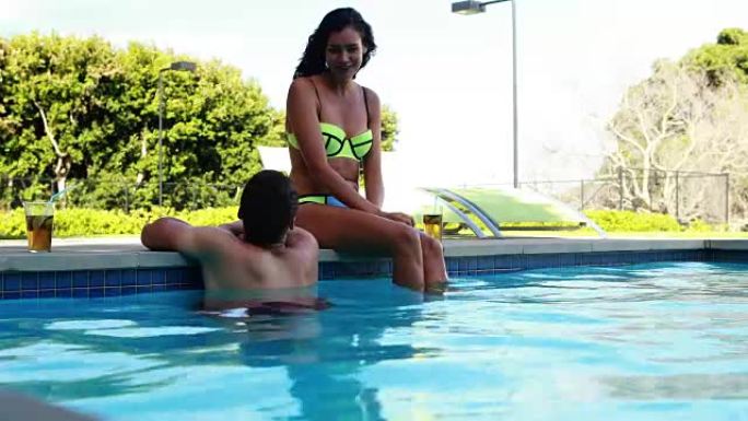 情侣在游泳池边互动