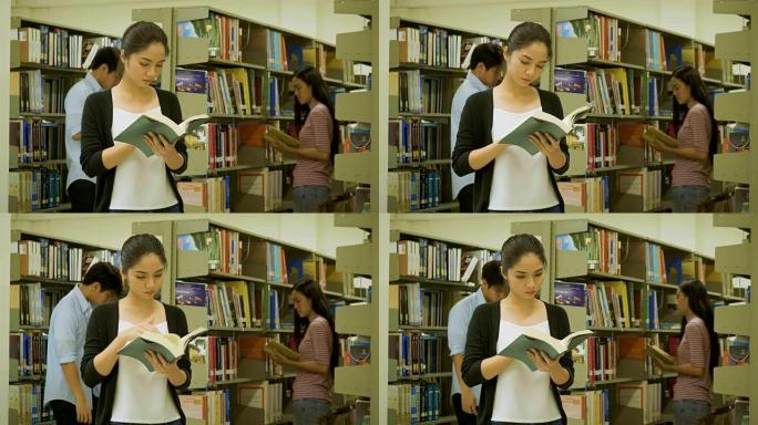大学生在书架旁边看书