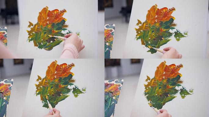 绘画的过程，在画布上涂抹颜料。