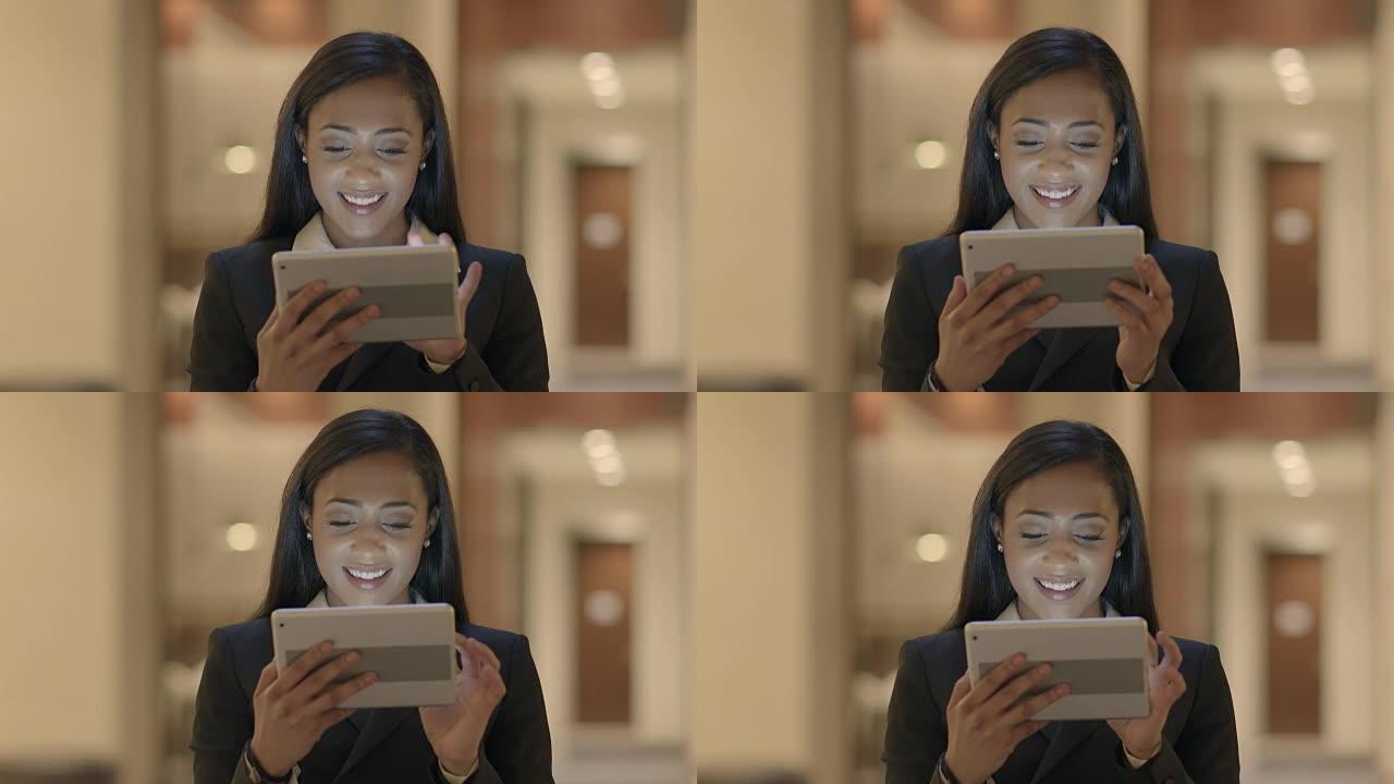 年轻迷人的黑人女性使用平板电脑在线搜索网络。穿着西装的非洲裔美国女性与社交媒体联系。城市生活背景