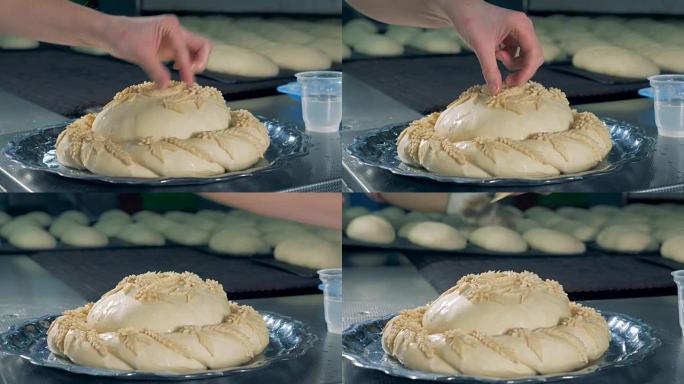 工人在添加馅饼之前先将馅饼装饰润湿。