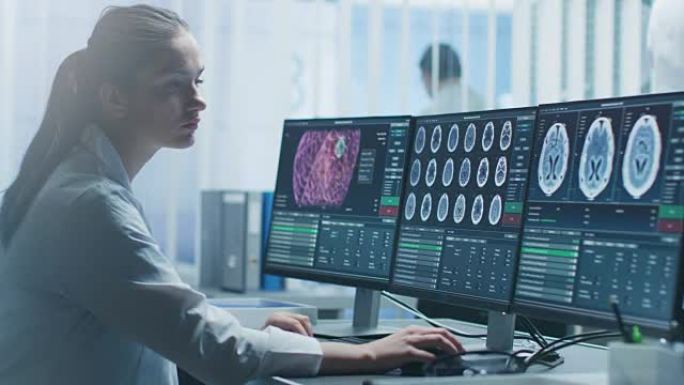 女性医学研究科学家在她的个人电脑上进行脑部扫描。现代实验室致力于神经生理学，科学，神经药理学。了解人