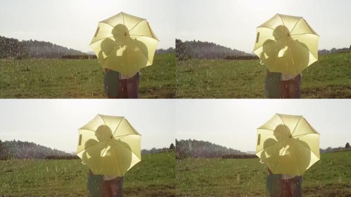特写: 浪漫约会的年轻夫妇正在亲吻隐藏在黄色雨伞后面