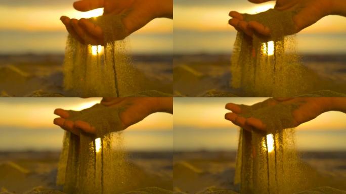 慢动作: 无法辨认的女人抓住一把干燥的沙子，让它掉下来
